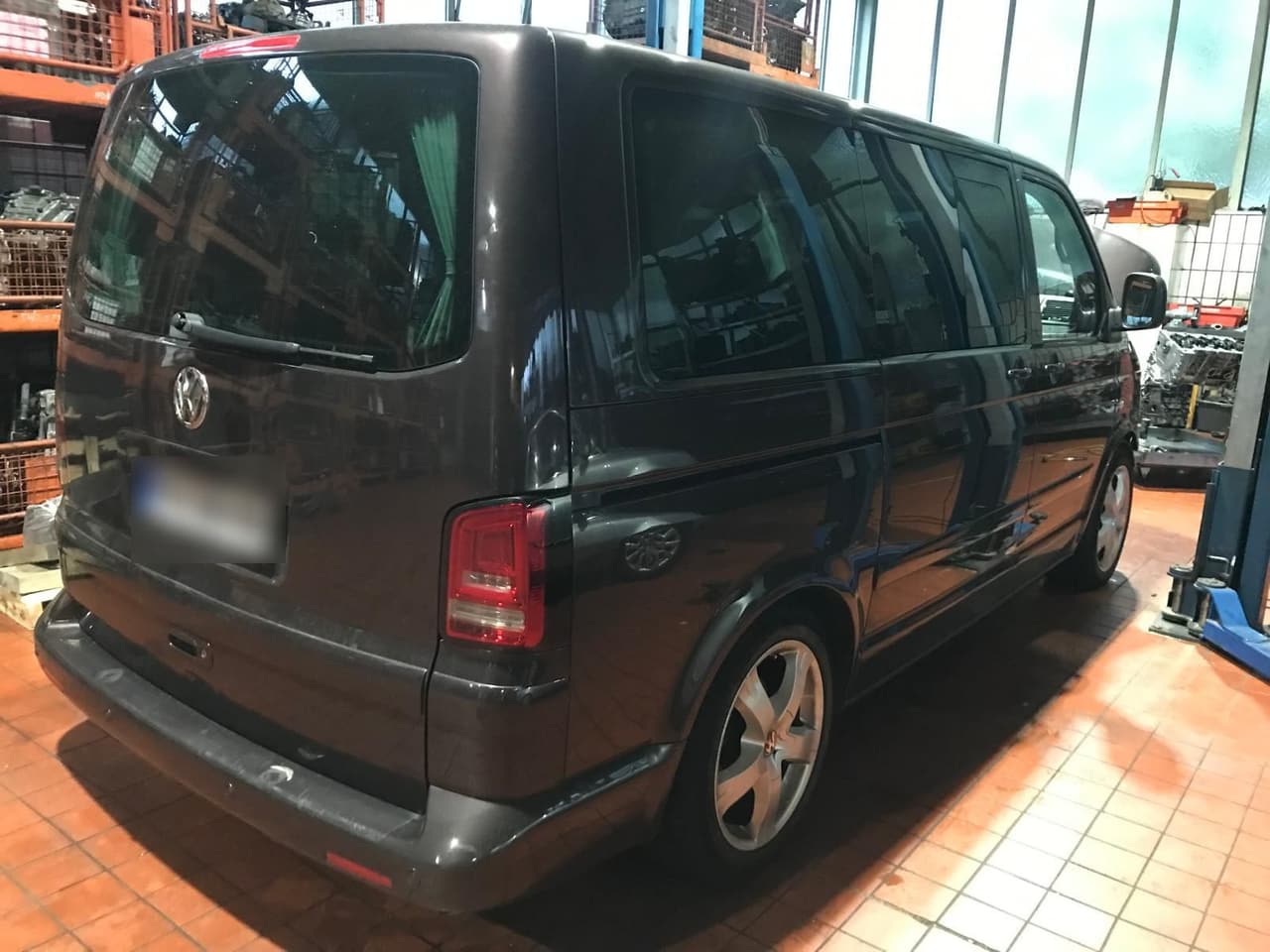 Dunkelgrauer VW T5 Multivan nach dem Facelift von schräg hinten in der Werkstatt
